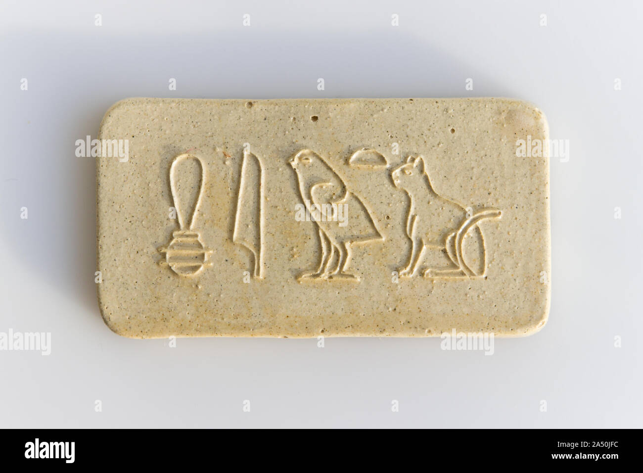 clay tablet with the inscription cat in ancient egyptian. modern