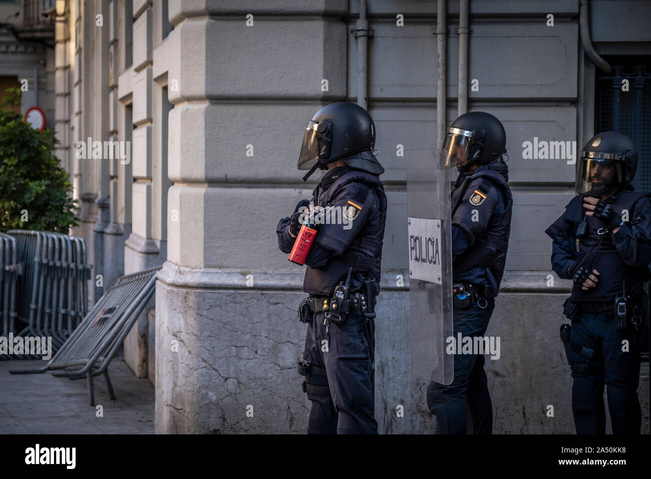 Policemen, stand on guard during the demonstration.Hundreds of protesters concentrated on the Gran Vía Street in Barcelona during the third day of protest following the sentences of the Spanish Supreme Court that condemns Catalan political prisoners to long prison terms. The demonstration culminated in front of the headquarters of the Department of Interior of the Generalitat with heavy police charges and barricades set on fire. Stock Photo