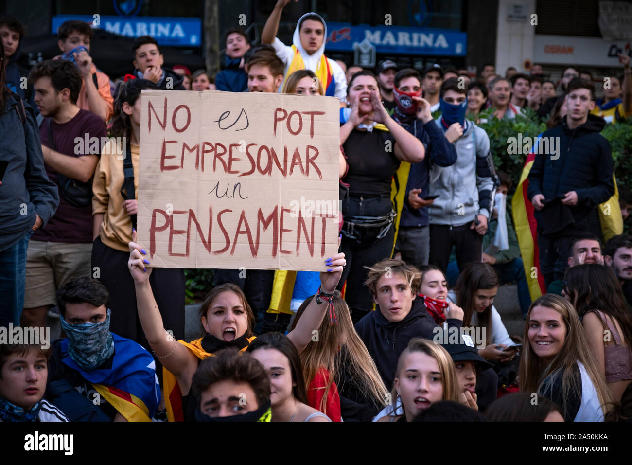 A protester chants slogans while holding a placard during the demonstration.Hundreds of protesters concentrated on the Gran Vía Street in Barcelona during the third day of protest following the sentences of the Spanish Supreme Court that condemns Catalan political prisoners to long prison terms. The demonstration culminated in front of the headquarters of the Department of Interior of the Generalitat with heavy police charges and barricades set on fire. Stock Photo