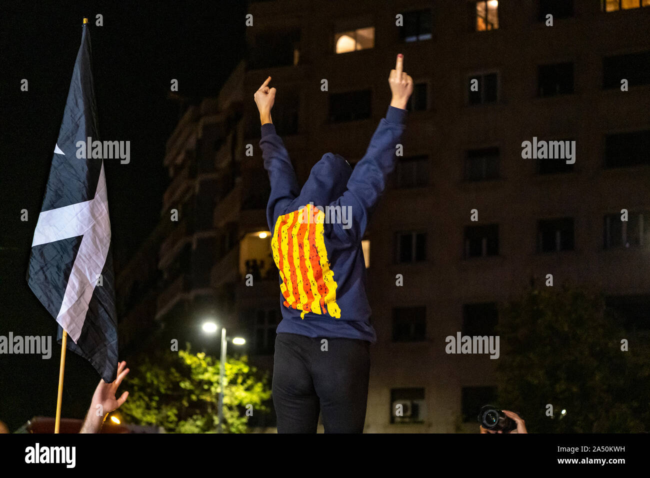 A protester makes gestures during the demonstration.Hundreds of protesters concentrated on the Gran Vía Street in Barcelona during the third day of protest following the sentences of the Spanish Supreme Court that condemns Catalan political prisoners to long prison terms. The demonstration culminated in front of the headquarters of the Department of Interior of the Generalitat with heavy police charges and barricades set on fire. Stock Photo