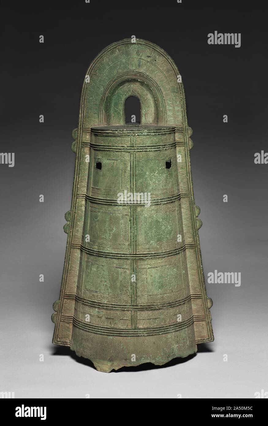 Dotaku, AD 100-200. The flow of new peoples from Korea to Japan during the Yayoi period brought new technologies of bronze and iron casting. Similarly, the form of the  dotaku , or bronze bell, is thought to have originated in Korea. The original Korean prototypes&#x2014;stout, thickly cast bells&#x2014;were transformed in Japan into sculptural forms with sophisticated surface decoration. These dotaku are often uncovered near burial sites paired with a metal spear or sword nearby, suggesting ceremonial importance. Stock Photo