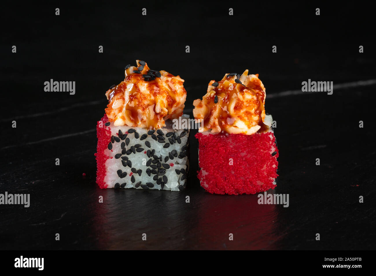 pair of sushi rolls chef de luxe close-up on a dark background Stock Photo