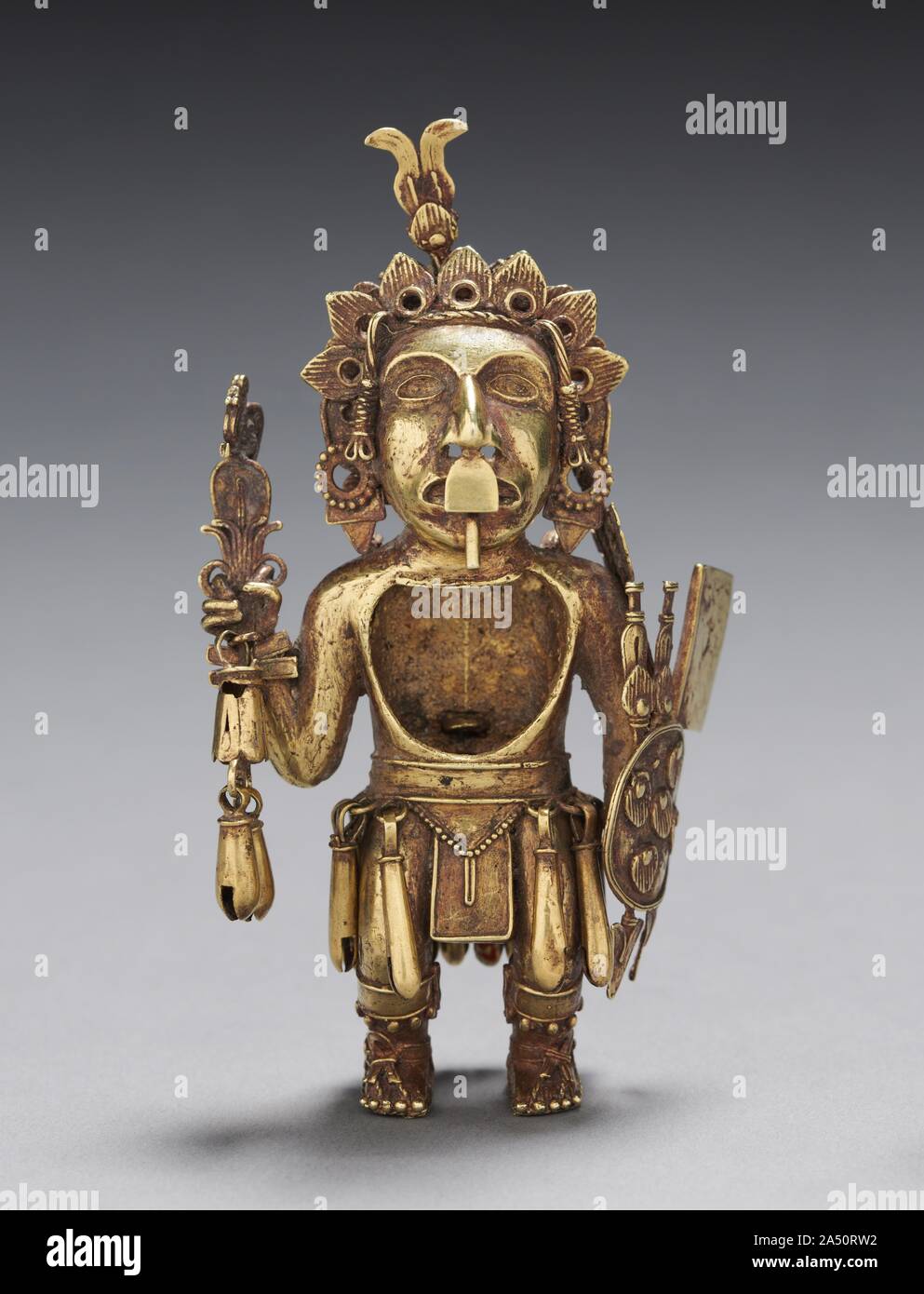 Figure of a Warrior, after 1325. The elite status of this warrior, who holds a dartthrower, darts, and a shield, is revealed by the gold from which he is made as well as his jewelry and sandals. Military accomplishment was prized by the Aztecs, whose imperial expansion was fueled by ambition as well as their belief that they were chosen to uphold cosmic order through war. The purpose of the chest cavity is unclear; the figurine may have been worn as a pendant. Stock Photo
