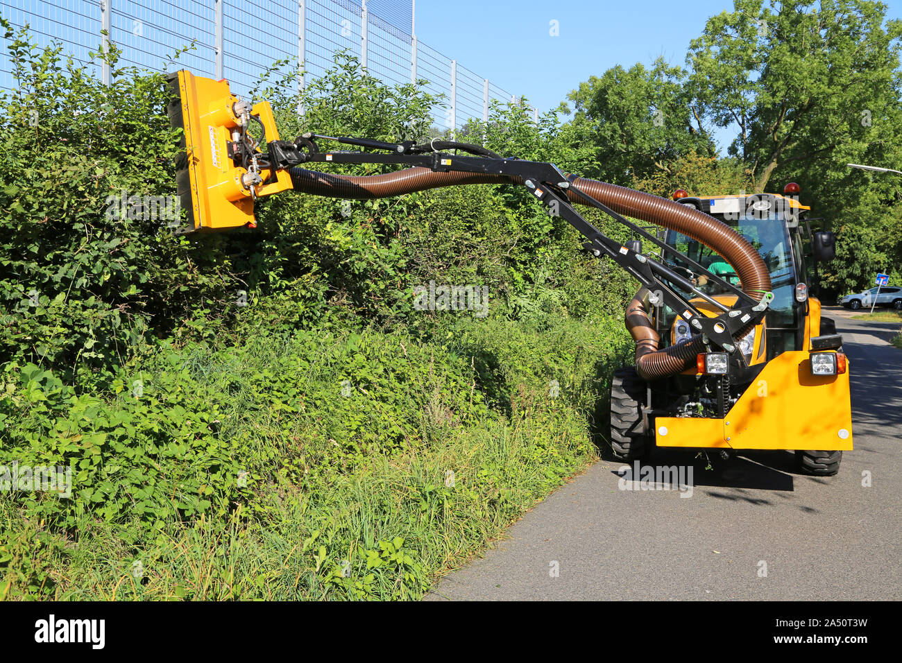 hedge trimming with tractor equipment Stock Photo Alamy