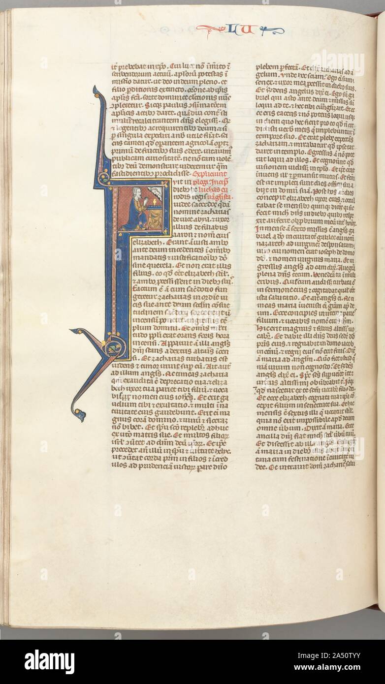 Fol. 412v, Luke, historiated initial F, Luke praying at an altar, bust of God above, c. 1275-1300. Biblical manuscripts were highly prized and important possessions of churches, monasteries, cathedral schools, and universities throughout medieval Europe. The biblical texts were known as the vulgate, the translations made by Saint Jerome in the fourth century from Hebrew and Greek into Latin, which became the definitive and official Latin version of the Roman Church. In the 13th century, the bible was, for the first time, produced as a single volume with an officially sanctioned sequence to its Stock Photo