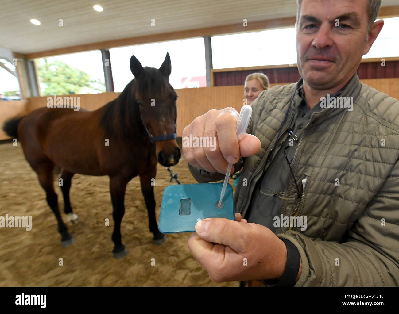 Tappendorf, Germany. 17th Oct, 2019. Peter Belz, head of the Tappendorf Horse Clinic, uses a prototype to demonstrate the function of a lightning test for equine diseases. With the minilab developed by researchers from Hamburg and Schleswig-Holstein, infections can be detected within 15 to 30 minutes. Previously, the samples had to be sent to laboratories and the results only came after three to five days. Credit: Carsten Rehder/dpa/Alamy Live News Stock Photo
