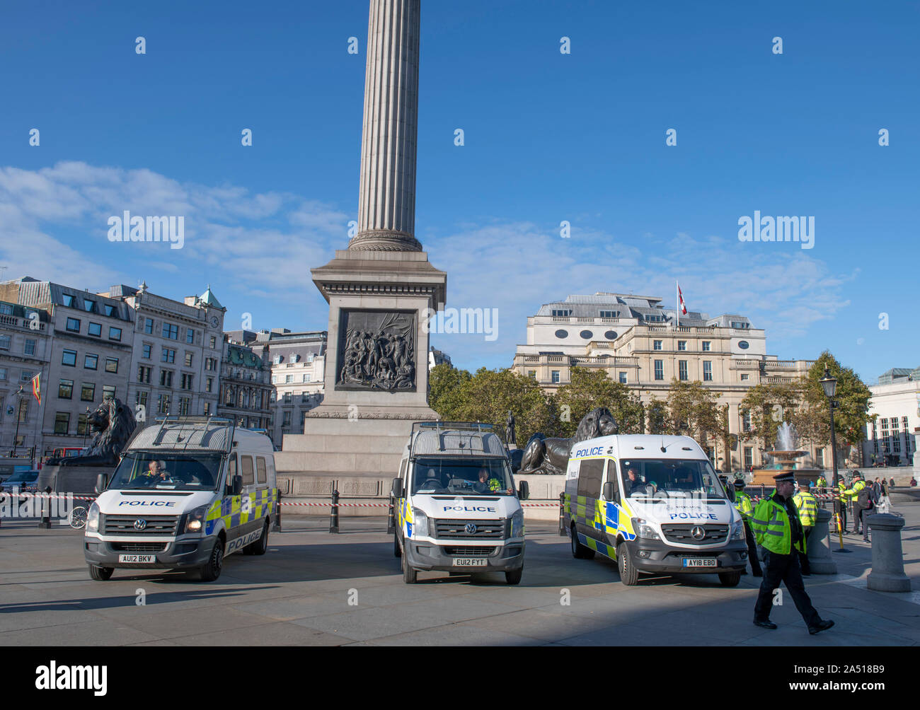 Trafalgar Square, London, UK. 17th October 2019. Large early morning police presence in Trafalgar Square after Extinction Rebellion climate change protesters were stopped from gathering in the area. Vans parked from Essex Police, Kent Police and Norfolk Constabulary. Credit: Malcolm Park/Alamy Live News. Stock Photo