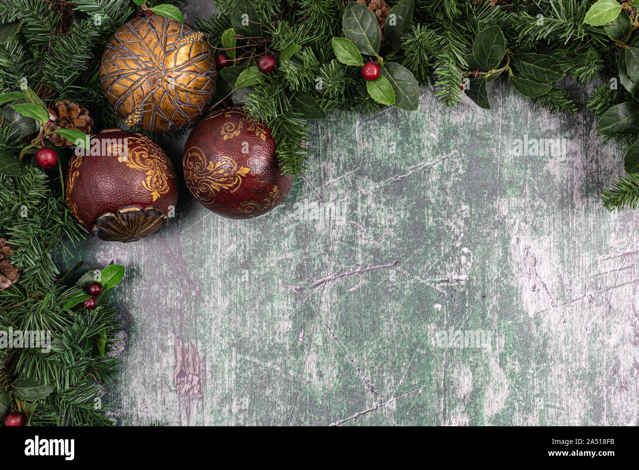 Christmas greenery and decorations against a rustic wood backdrop