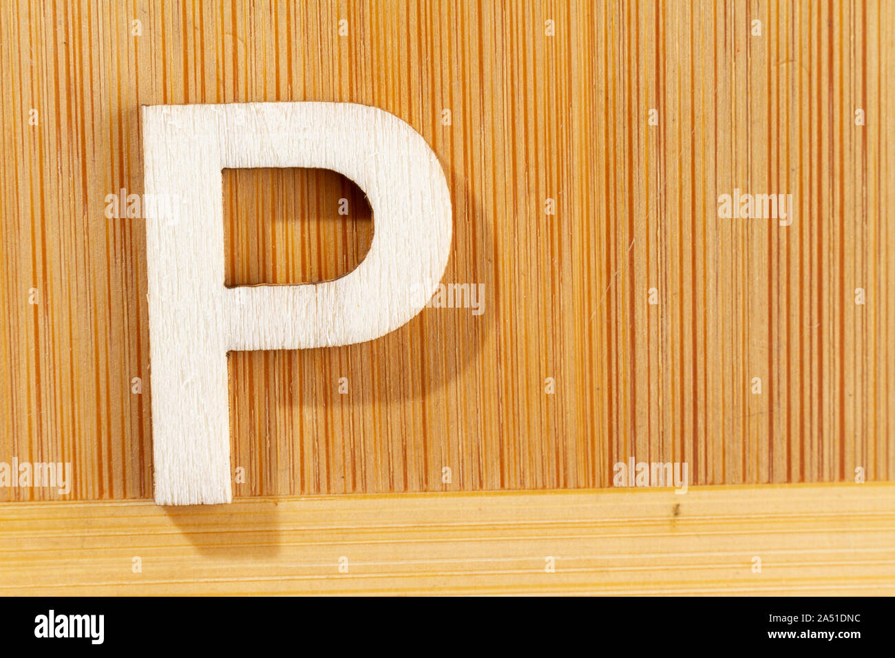Letter P of wood-made alphabet, top view and space for text Stock Photo