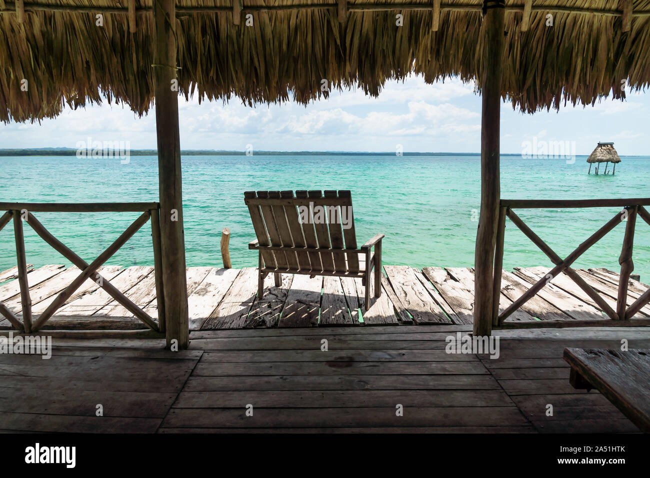 Dock with chair with view on lake Itza, El Remate, Guatemala Stock Photo