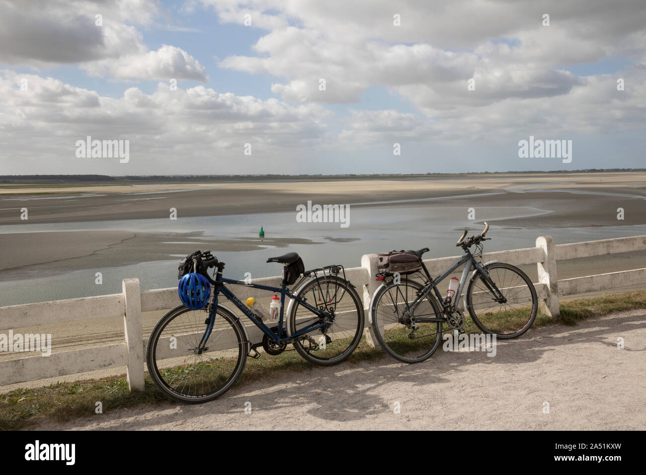 Cycles leaning on fence, Le Crotoy, Picardy. cycle touring Stock Photo