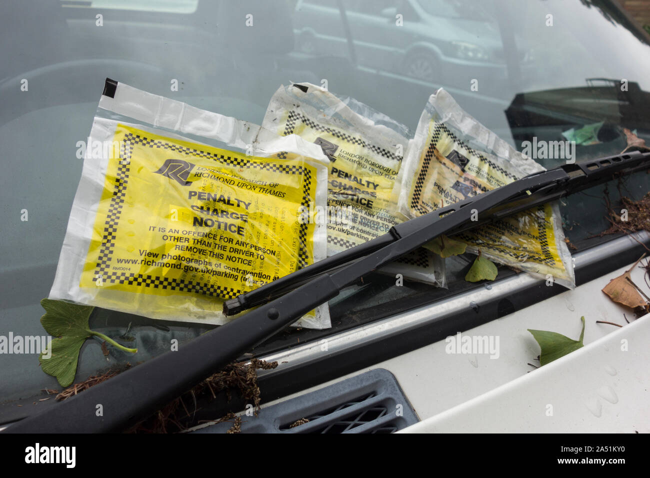 Three penalty charge notice tickets on a car windscreen in London, England, UK Stock Photo