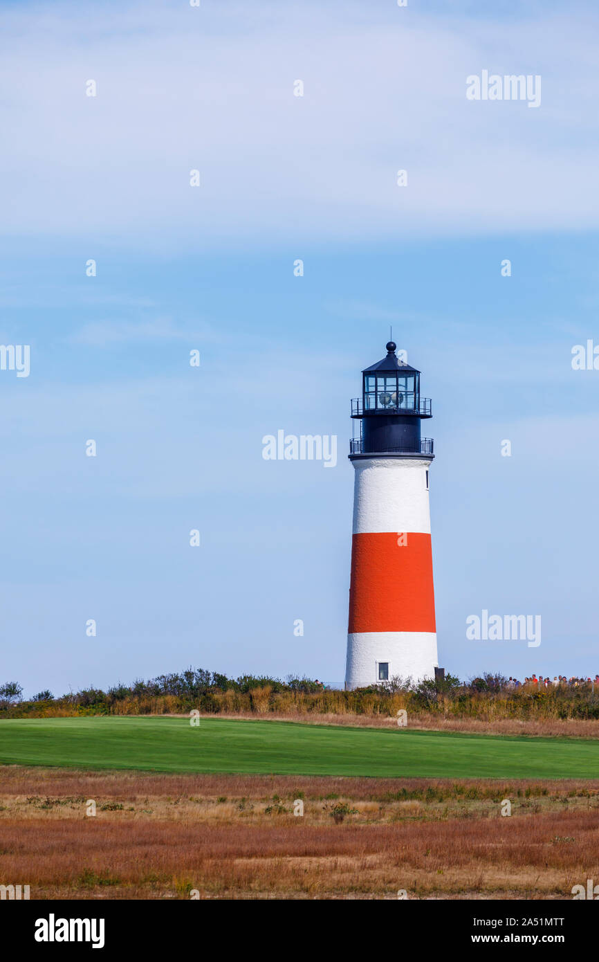 Skyline view of red and white Sankaty Head Light and golf course