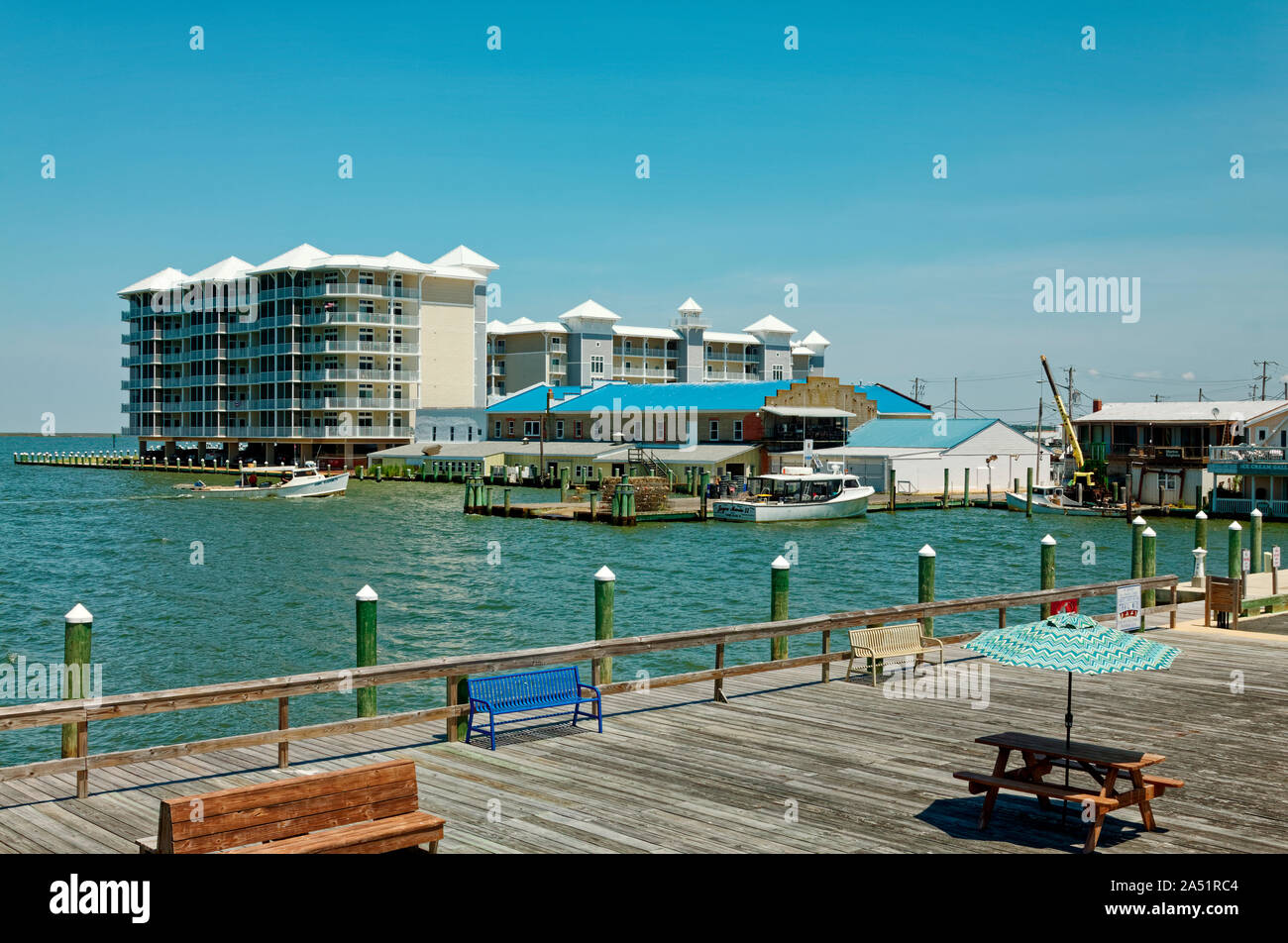 waterfront scene; pier; modern condominiums; boats; old buildings