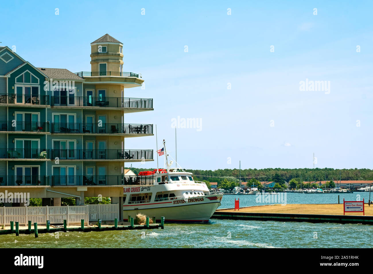 tour boat underway; passing modern condominium building; narrow