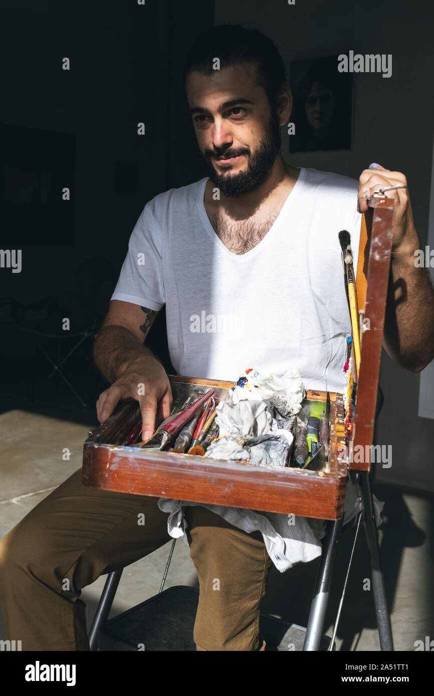 young painter teaches us his tools to work Stock Photo