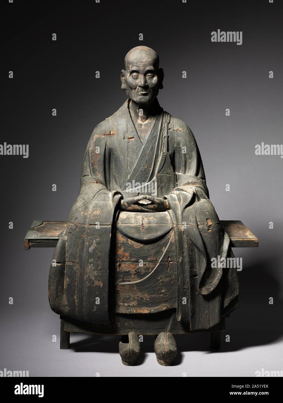 Portrait of Hotto Enmyo Kokushi, 1286-1333. Hotto Enmyo Kokushi, is a posthumous title bestowed upon the Zen Buddhist monk Shinchi Kakushin (1203-1298) by the emperor Go-Daigo. The title means &quot;perfectly awakened national teacher of the Dharma lamp.&quot; Compared with two sculptures of the monk created during his lifetime (both in and around 1275), this sculpture portrays Kakushin as a much older man. It comprises multiple wood blocks, with the main parts being the front, back, and the head, which is inserted into the body. Although only the lacquer remains today, the sculpture would onc Stock Photo