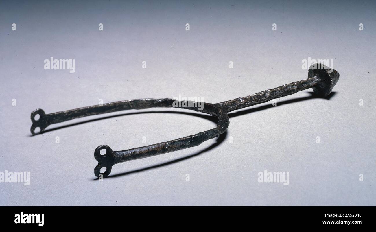 Pricked Spur, 1200s. The spur was an essential part of the knight's equipment. Fastened to his heels by means of straps and buckles, it was used to prod a horse into action. These examples represent the oldest type recorded, the &quot;pricked&quot; spur, so-called because its neck terminated in a spike. The pricked spur was replaced during the Middle Ages by the &quot;rowel&quot; spur, with a rotating spiked wheel. Stock Photo