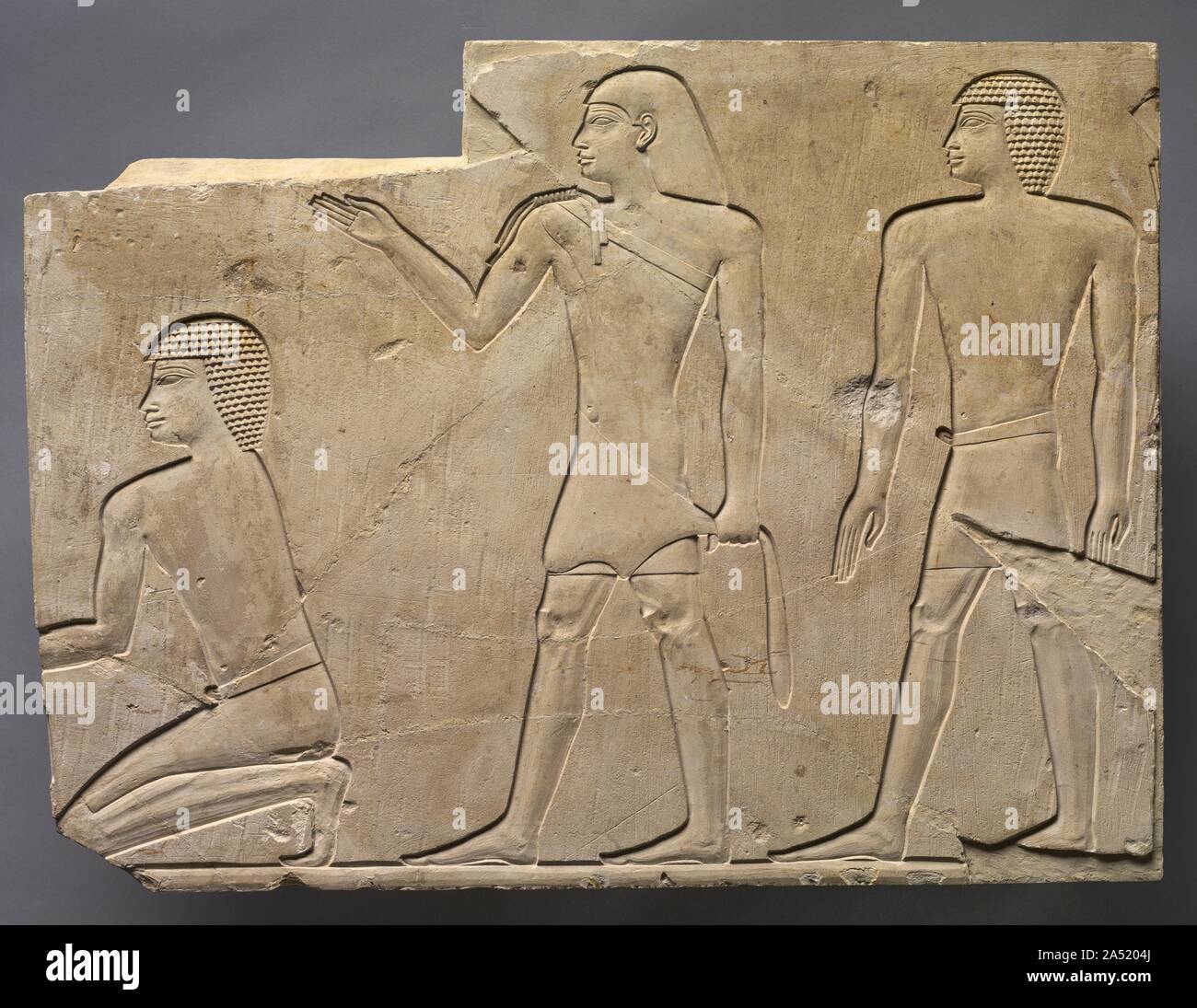 Priests Performing Funeral Rites, c. 667-647 BC. A priest and two attendants perform ceremonies for the deceased. Originally, there probably existed (to the left) certain offerings. It is an exact copy of a scene in the Temple of Deir el Bahari made some seven centuries earlier where the figures are reversed. Stock Photo