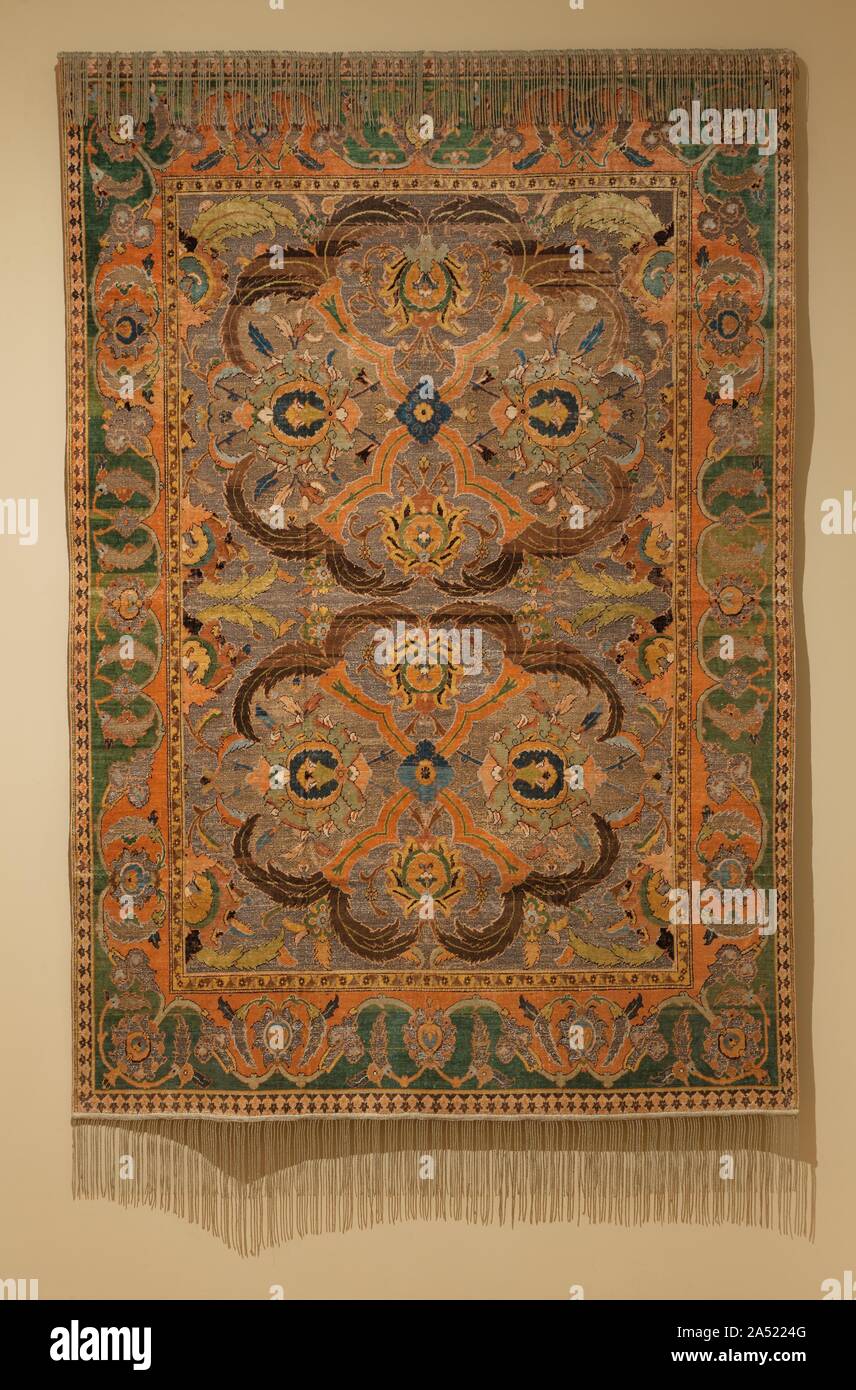 Royal Carpet with Silk and Metal Thread , 1600-1625. Brilliant colours of silk carpet-pile form this rich foliate and floral pattern on (originally shiny) gold- and silver-thread grounds. This radiant Iranian carpet was woven in a royal workshop of Shah &#x2019;Abbas I in Isfahan. The Shah presented similar coveted carpets as imperial gifts to kings of Islamic and Christian countries. In Denmark, one carpet looks sparkling new because it is reserved for coronations. This group with silk and metal thread is mistakenly called &quot;Polish,&quot; based on one displayed in the Polish exhibit at th Stock Photo