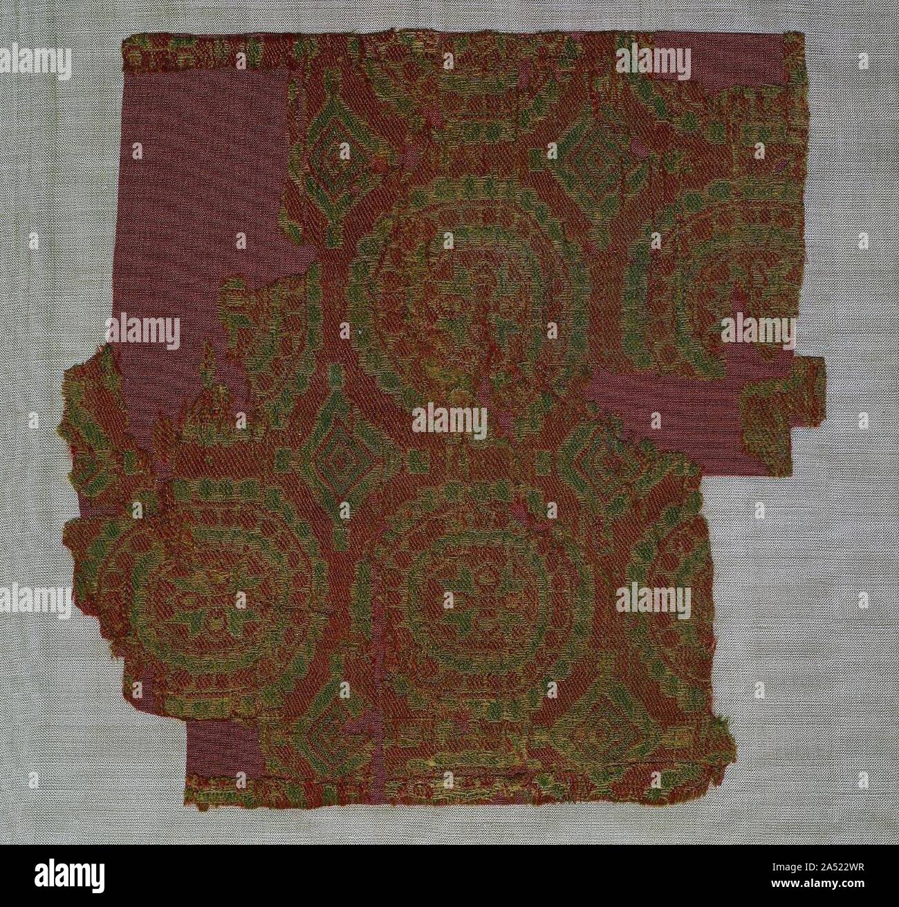 Samite with roundels of rosettes, 700s-800s. This is one of a large number of silks woven with geometric designs that have traditionally been attributed to Sogdiana. However, the untwisted warps and light weight of the silk indicate that it was woven farther east in Central Asia where Sogdian influence was strong. Similar geometric patterns occur on clothing depicted in paintings found in the Khotan oasis. That region maintained close cultural and economic ties with Sogdiana. Whether this silk was woven in the Khotan oasis or elsewhere in Central Asia is not known. Stock Photo