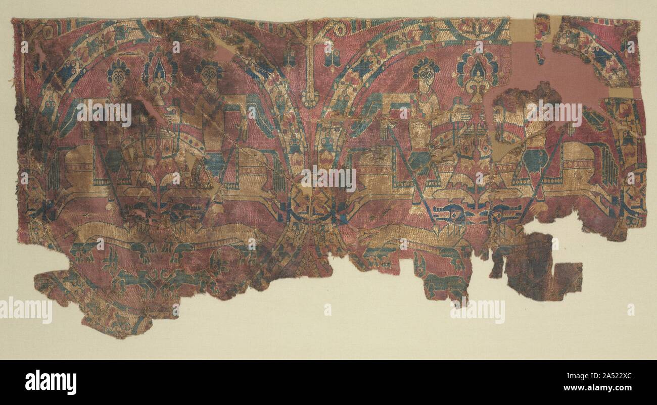 Samite roundels with hunters, 800s. These textiles are woven with floral roundels that enclose horsemen hunting lions. The theme of horsemen hunting with lances, the floral frames of the roundels, and the costumes of the hunters were all inspired by silks from the Byzantine world. The stiff, abstracted style, however, is characteristic of Sogdian silks. Silks woven in Sogdiana were often traded to distant markets. These fragments were preserved in an Egyptian grave where they were found sewn as ornaments onto a tunic. Stock Photo