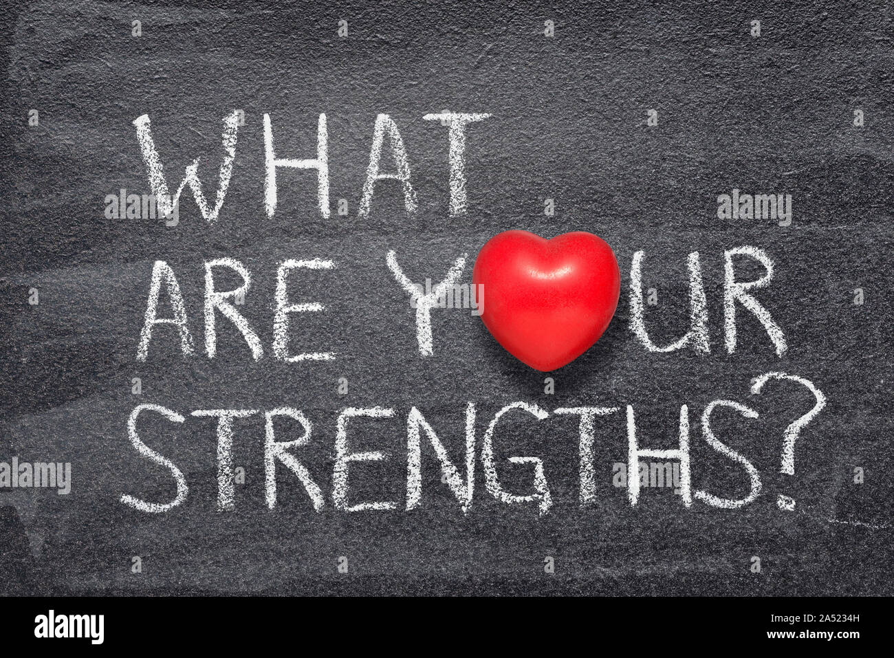 what are your strengths question handwritten on chalkboard with red heart symbol instead of O Stock Photo