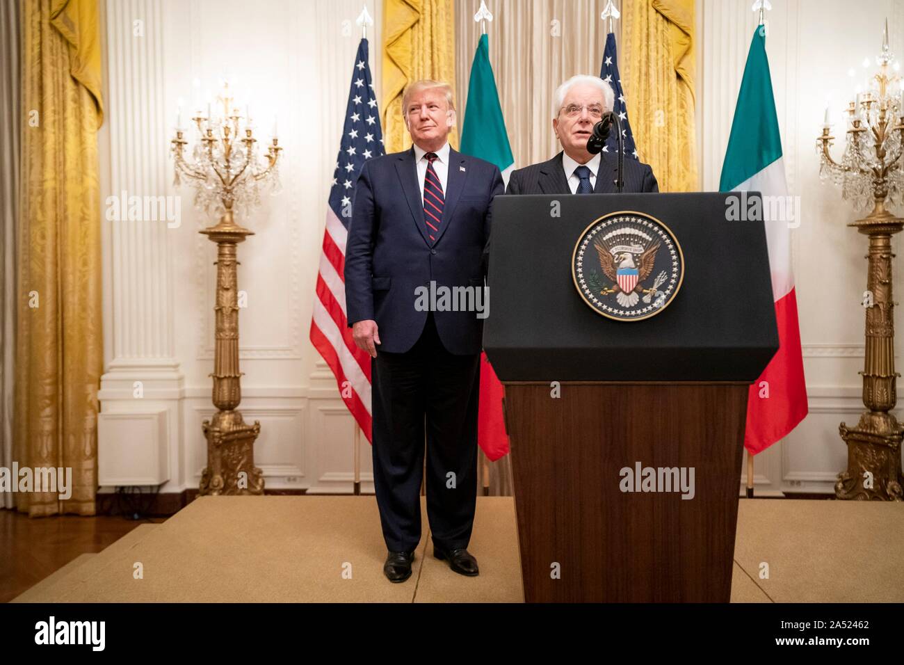 Washington, United States of America. 16 October, 2019. U.S President Donald Trump, left, looks on as Italian President Sergio Mattarella delivers remarks during a reception in the East Room of the White House October 16, 2019 in Washington, DC. Credit: Tia Dufour/White House Photo/Alamy Live News Stock Photo