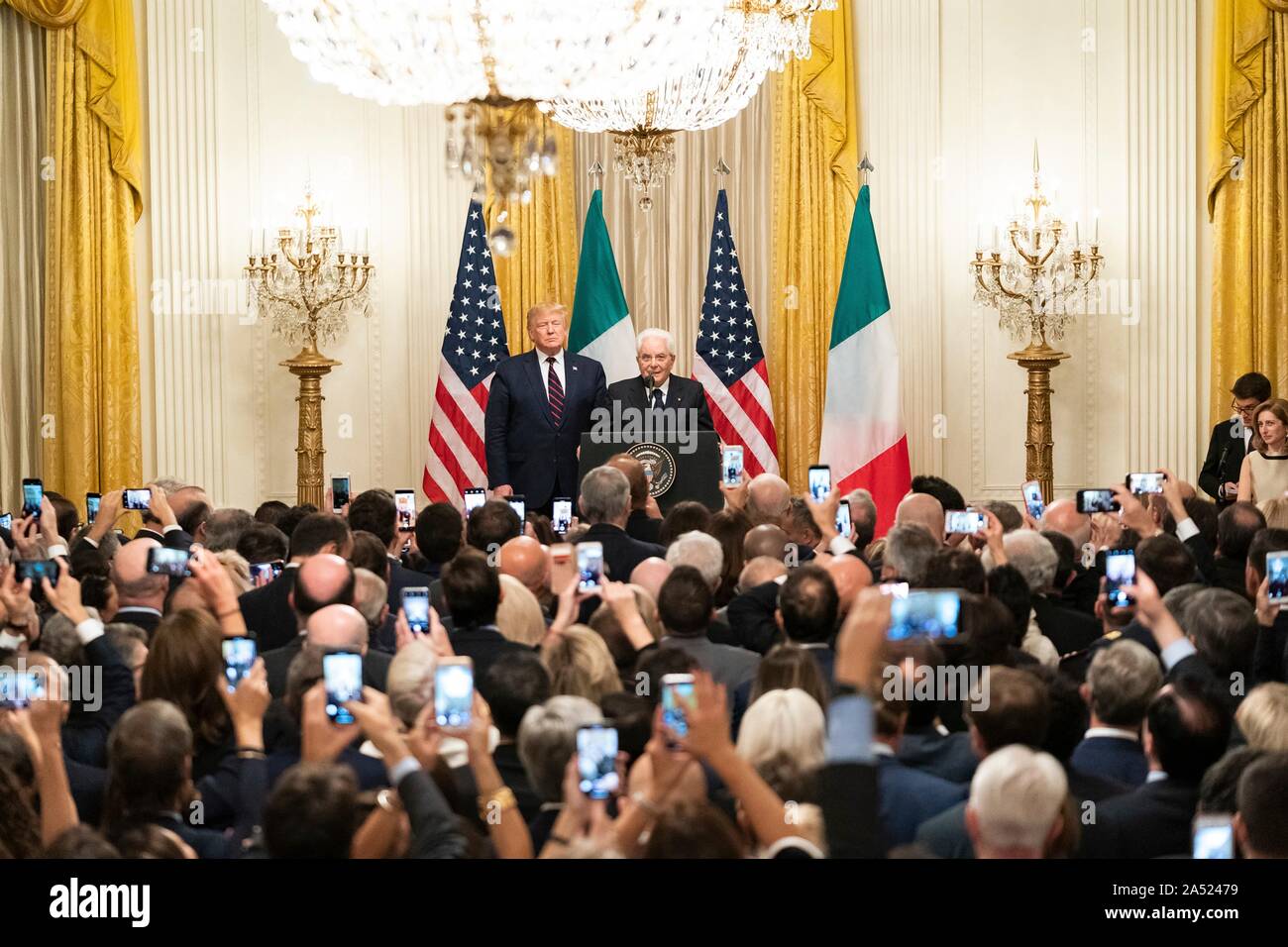 Washington, United States of America. 16 October, 2019. U.S President Donald Trump, left, looks on as Italian President Sergio Mattarella delivers remarks during a reception in the East Room of the White House October 16, 2019 in Washington, DC. Credit: Andrea Hanks/White House Photo/Alamy Live News Stock Photo