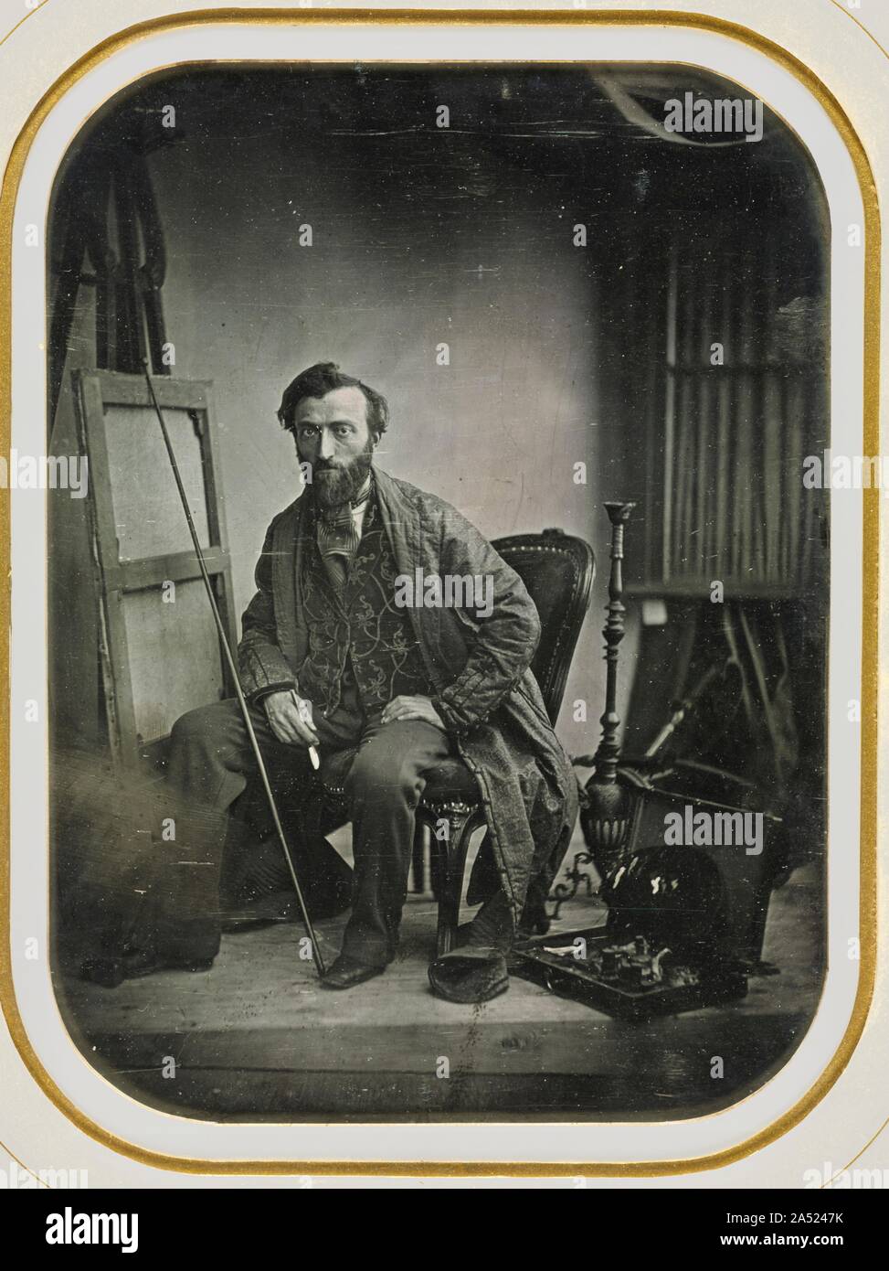 Self-Portrait in Painting Studio, c. 1843. Many of the best early photographers were artists who put their training in figural arrangement, light and shadow, and composition to good use in the new medium. Dolard, a portrait painter, may have offered photographs to prospective clients of lesser means. In this image, possibly made as an advertisement for his studio, he identifies himself as a painter, surrounded by the tools of the trade. The coat and the hookah suggest an interest in orientalism, a fashion that occupied many mid-19th-century artists. A remarkable technical achievement, this who Stock Photo