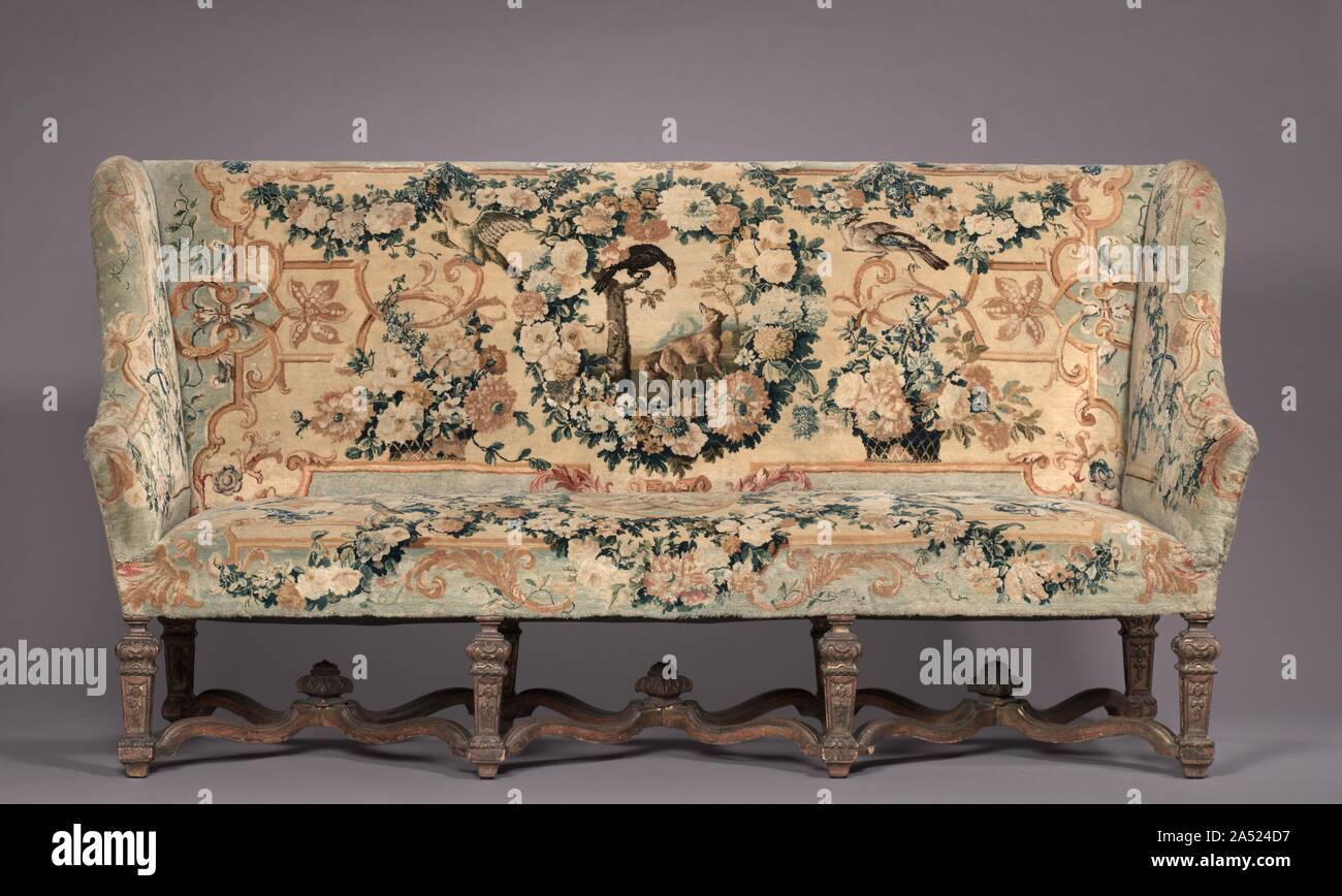 Settee, before 1717. These chairs belong to a suite that includes a settee (also in the CMA&#x2019;s collection) and a tapestry made for a count and countess to mark their wedding in 1717. Furniture of this scale was usually placed against the wall in grand reception halls, more as a display of wealth than for use. Upholstered in Savonnerie tapestries, this suite was among the most treasured and expensive example anyone could own and typically reserved for royalty.    To add decorative and intellectual interest to the textiles, weavers incorporated symbols depicting various stories from the  F Stock Photo