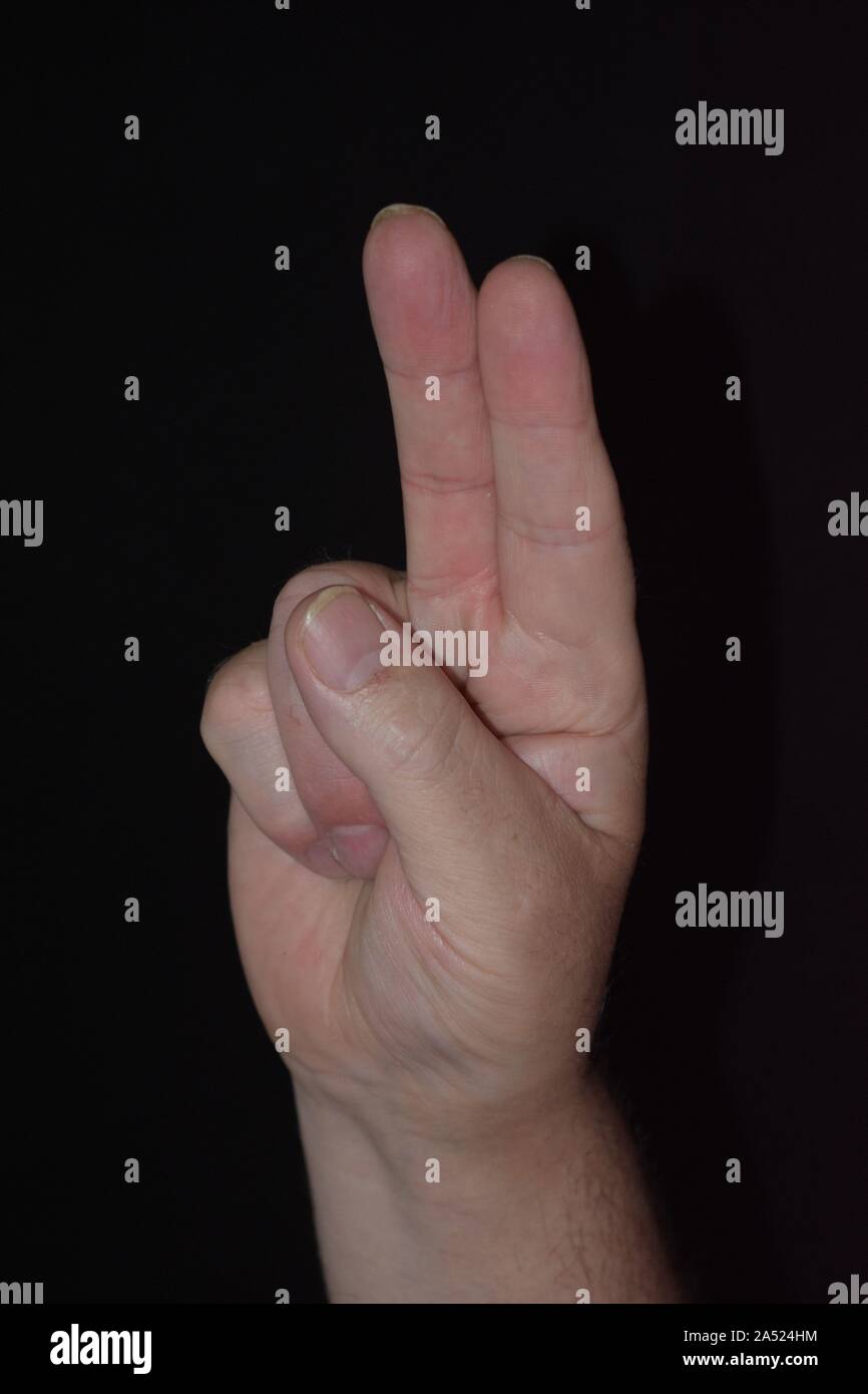 Hand Gesture holding up two fingers Stock Photo Alamy