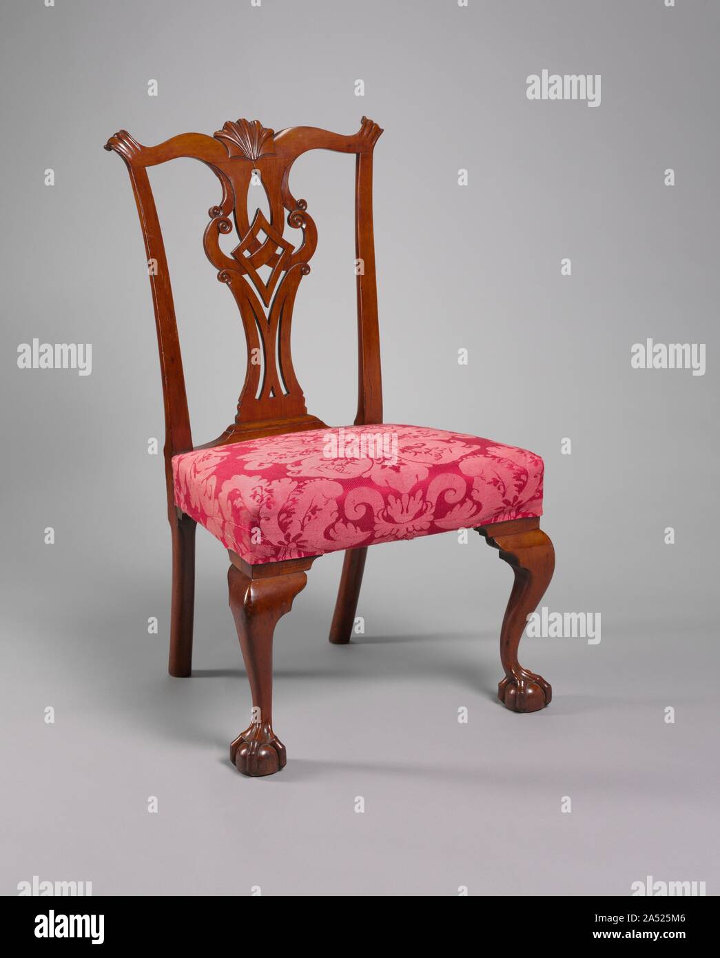 Side Chair, c. 1775. Before becoming one of the best known Connecticut furniture makers of the late 1700s, Eliphalet Chapin worked in New York City and Philadelphia. His furniture shows evidence of that experience. For example, the back of this chair has a splat design found on New York pieces, while the untapered rear legs and the shell carving on the crest rail are typical of Philadelphia workmanship. The use of cherry, however, is characteristic of Connecticut furniture. This chair comes from a set recorded in Chapin's account book as having been supplied to Ebenezer Grant to form part of t Stock Photo