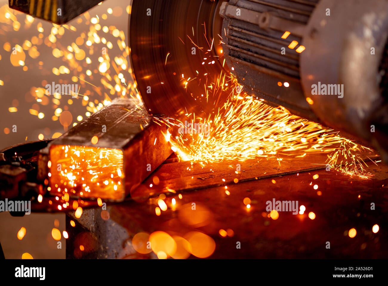 Cutting industrial metal with grinder. Sparks while grinding iron. Stock Photo