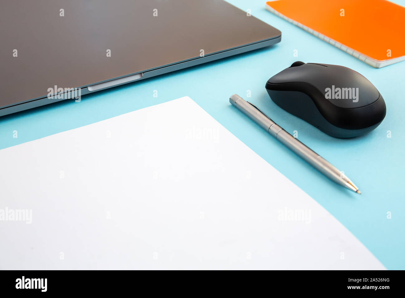 Minimal work desktop with laptop, blank white page with copy space, pen ...