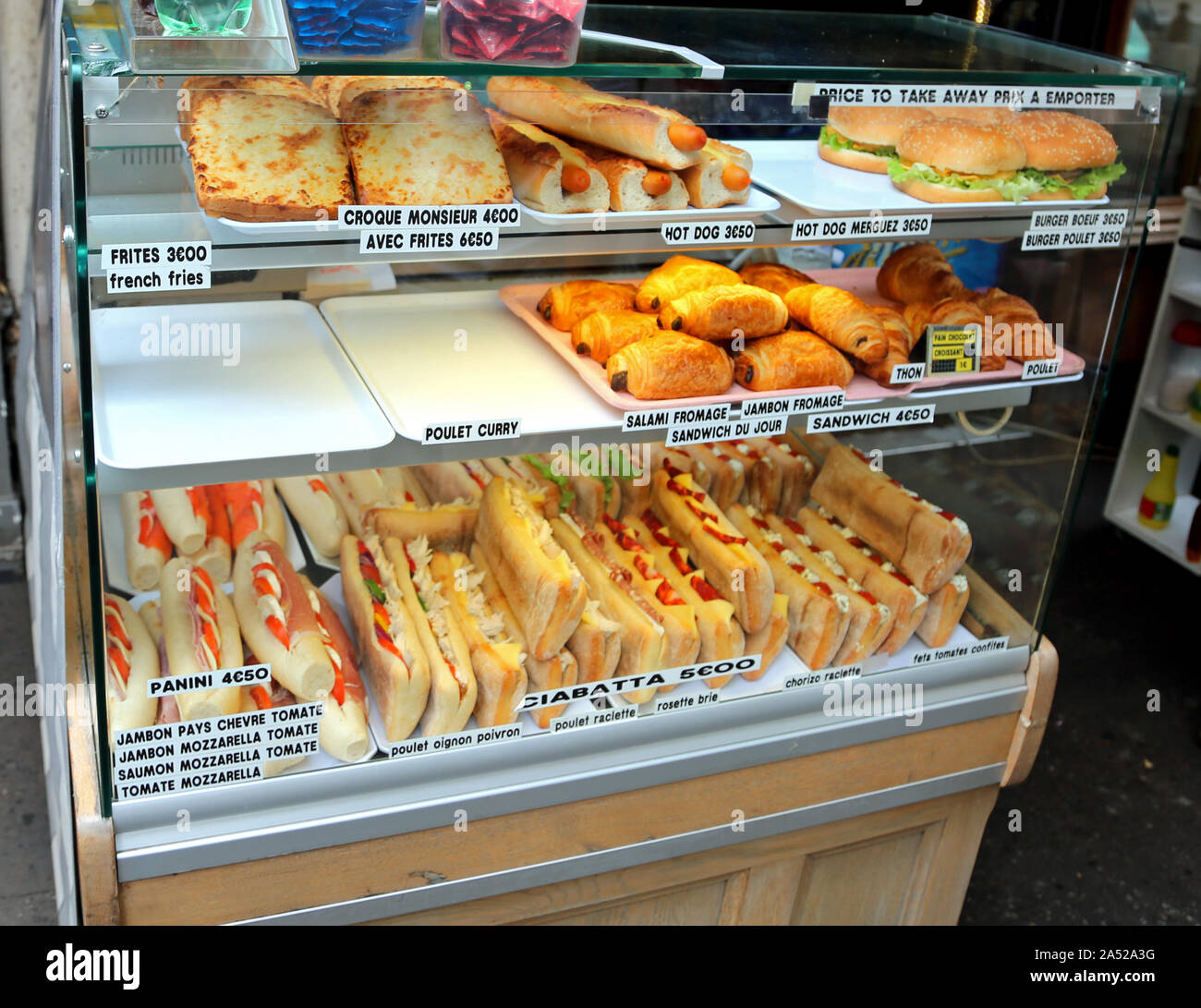 display of bar with many sandwiches in France with name of food in