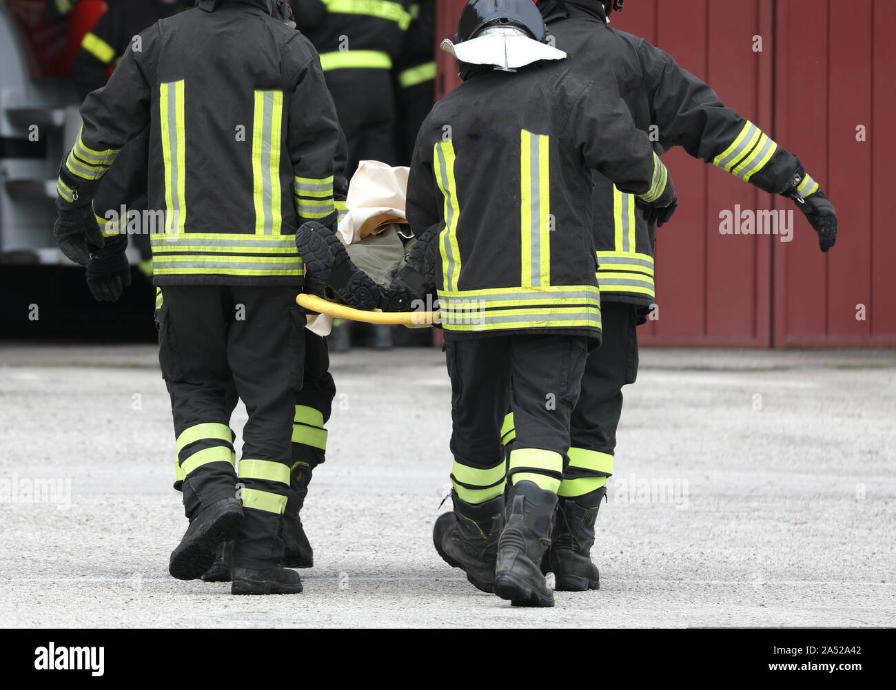 Four Firefighters Carrying Injured After The Road Accident Stock Photo 