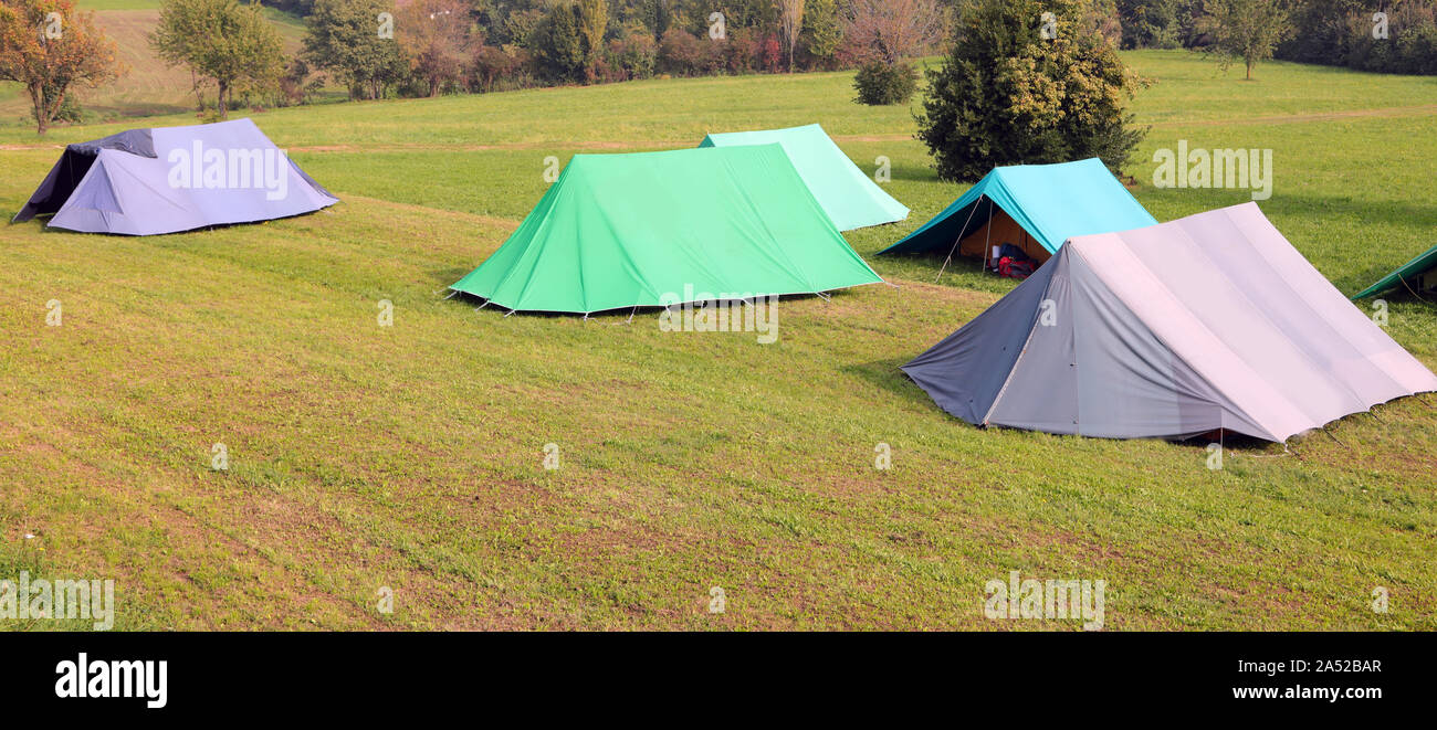 many tents at camp scout on the meadow of the hill in summer Stock Photo