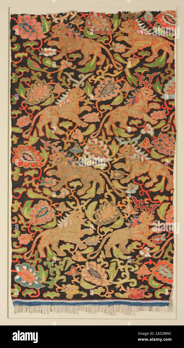 Tapestry with golden lions and palmettes, 1200s or earlier. This colourful, robust pattern features spirited Iranian golden lions, traditional symbols of royalty, amid large palmette leaves on vines that repeat, facing alternate directions in an asymmetrical Chinese-inspired layout. The regular repetition of the design indicates that it was influenced by silk patterns that were preset on large drawlooms, whereas variations in the motifs and colours confirm it was woven by hand in the tapestry technique. The pattern was created with silk thread in 13 rich colours and gold thread on parchment st Stock Photo