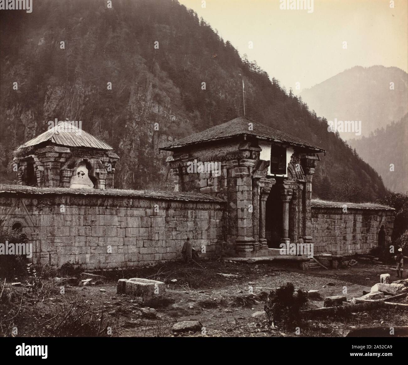 Temple at Naveshera, Kashmir, India, 1864. One of the most important British expeditionary photographers, Samuel Bourne was propelled by his great desire to travel to lovely, remote locations and to record images of what he considered picturesque. From 1863 to 1869, he worked widely in India, making three major expeditions to the Himalayas. This exquisite photograph of the decaying Temple of Naveshera was taken on his nine-month, second journey to this stunning, mountainous terrain. He balanced the ordered, constructed architectural forms with glimpses of the majestic natural landscape. Bourne Stock Photo