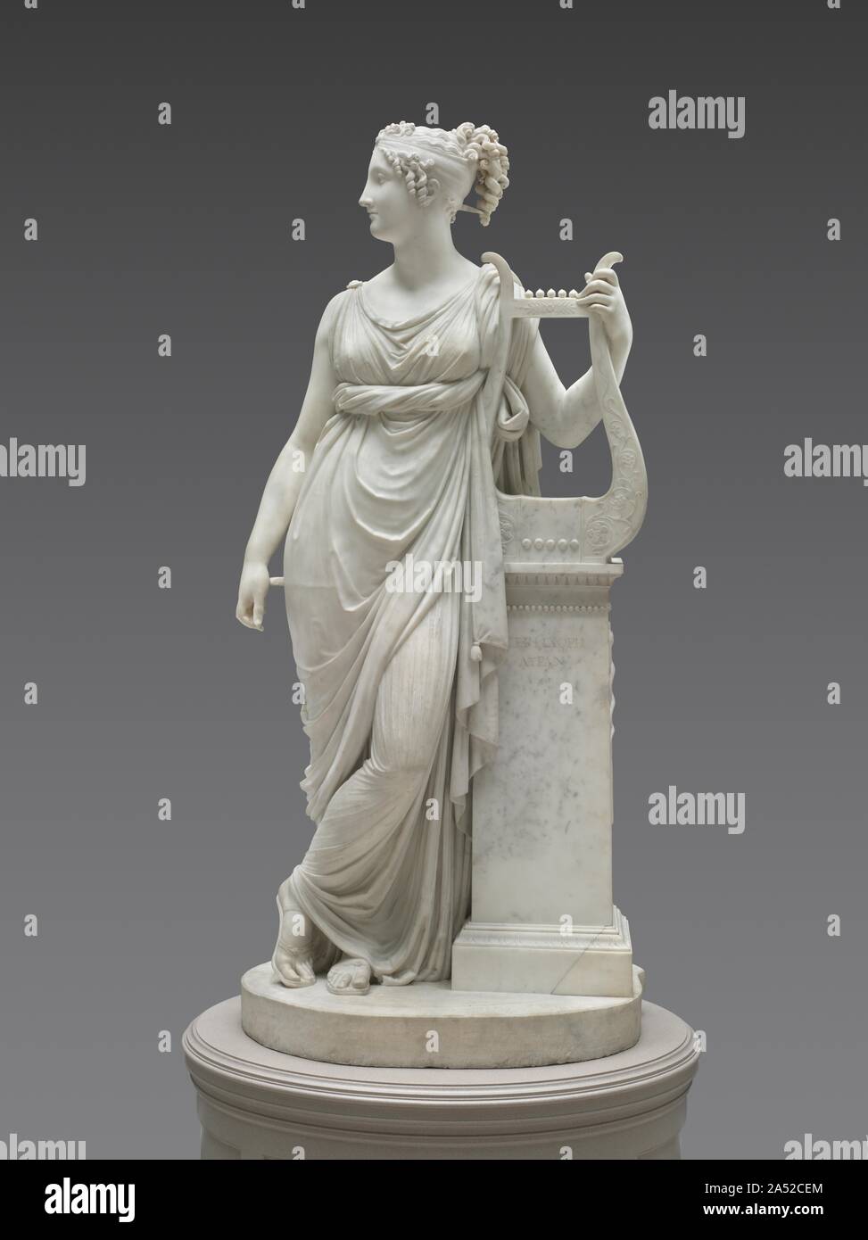 Terpsichore Lyran (Muse of Lyric Poetry), 1816. In Greek mythology, Terpsichore was one of the nine Muses, or goddesses of creative inspiration. The lyre, the Greek inscription on the short column, and the caduceus (entwined snakes) on the side identify the figure as Terpsichore Lyran, muse of lyric poetry. This sculpture began with a commission from Napoleon's brother, Lucien, for an idealized portrait of his wife, Alexandrine. Antonio Canova made this version for a British aristocrat and exhibited it in 1817 at the Royal Academy in London to great acclaim. Stock Photo