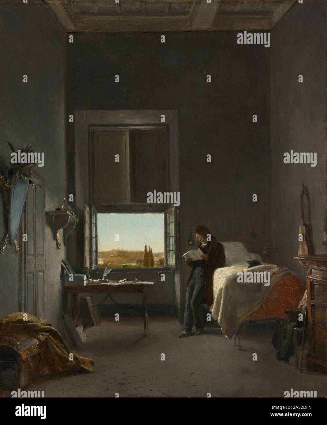 The Artist in His Room at the Villa Medici, Rome, 1817. In 1817, Cogniet won the Prix de Rome for history painting, a state prize that allowed him to live and work at the Villa Medici for a period of five years. The helmet, shield, and swords depicted on the left wall near the doors that lead to the studio refer to the expectation that Cogniet would produce a history painting each year to send back to Paris for review. On the back of this painting the artist wrote (in French): &quot;My room at the reception of my first letter from my family, 1817.&quot; The open window with the landscape view Stock Photo