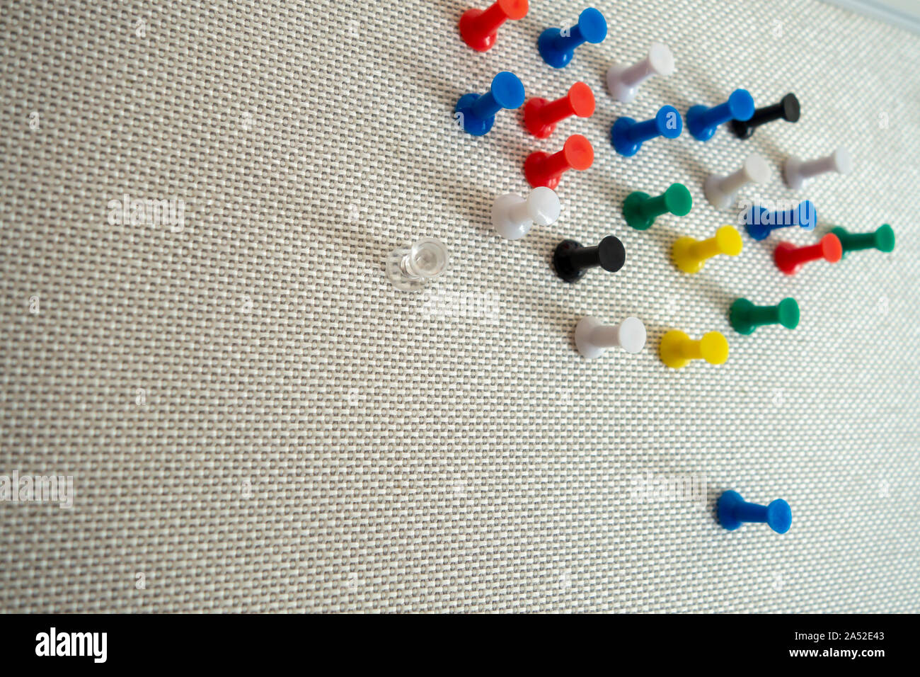 different color thumb tacks, on a conference room office board. Stock Photo