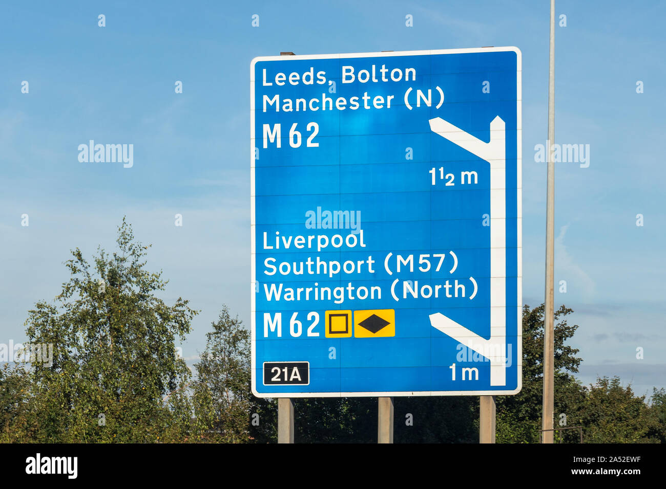 UK motorway sign showing directions to M62 Liverpool, Warrington, Southport (M57) and M 62 Leeds, Bolton, Manchester, UK Stock Photo