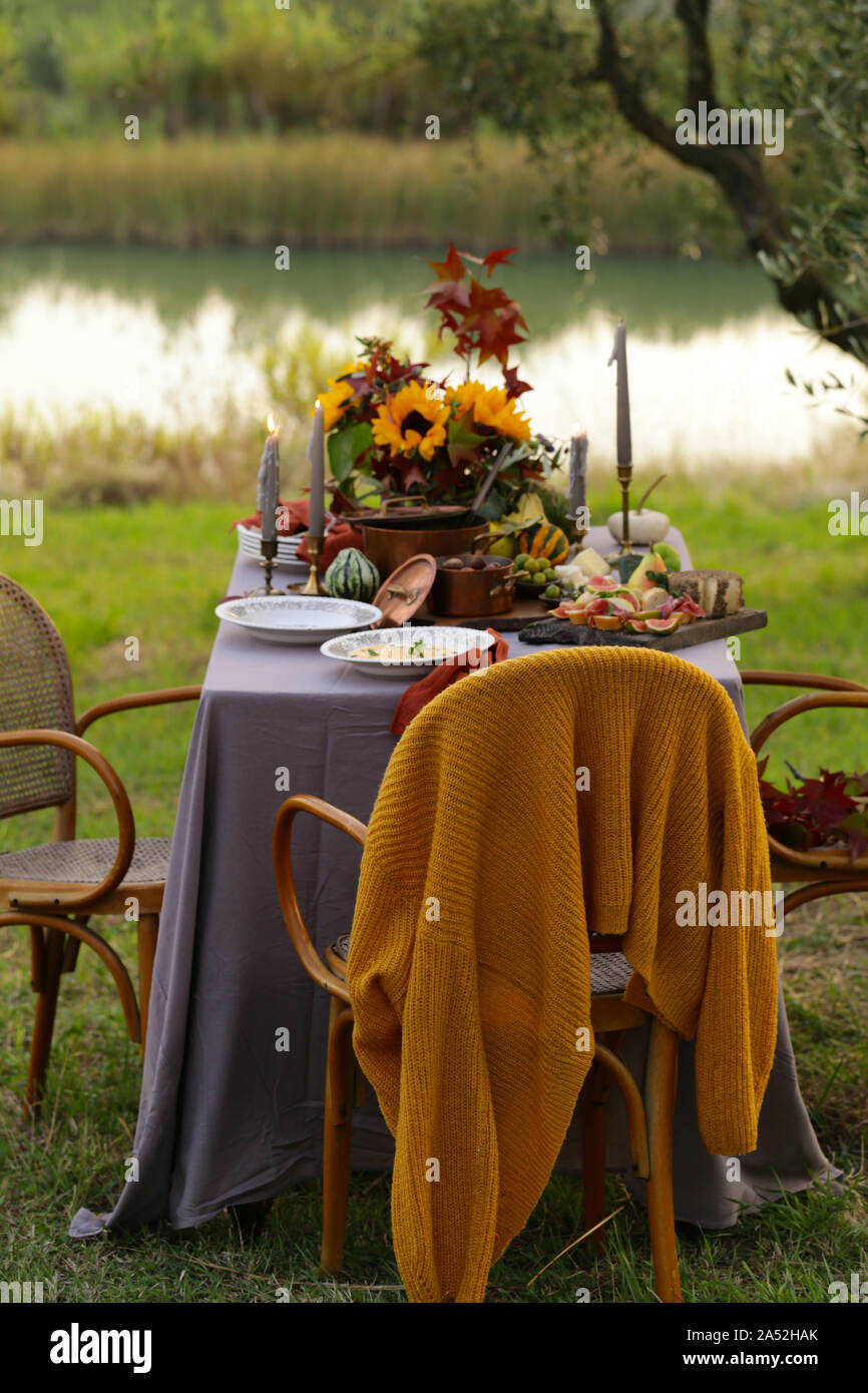 Autumn table setting with pumpkin soup and chestnuts Stock Photo - Alamy