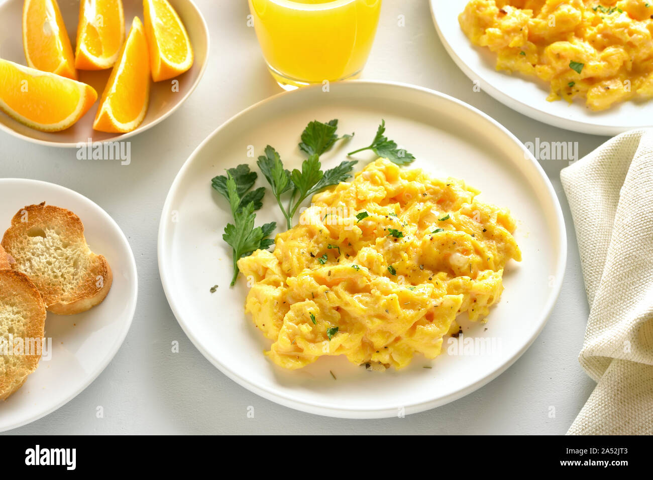 Scrambled eggs on plate over white stone background. Stock Photo