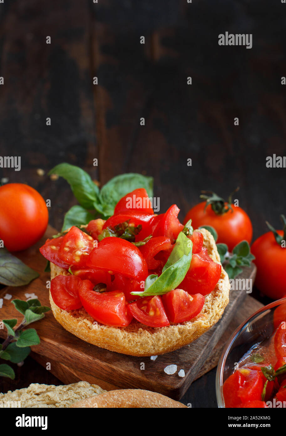 Frisella, typical south italian bread seasond with tomatoes and herbs Stock Photo