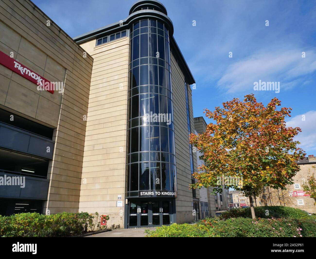 The rear entrance to kingsgate shopping centre with dark glass atrium staircase leeding to parking and shops in Huddersfield off the lower ringroad Stock Photo