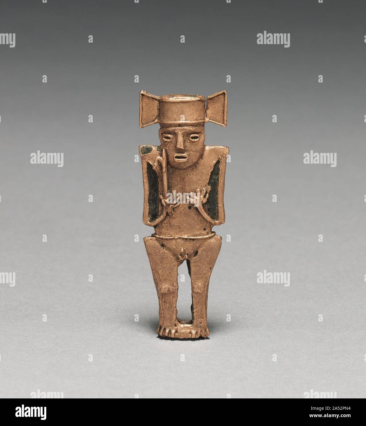 Tunjos (Votive Offering Figurine), c. 900-1550. Unlike the other gold ornaments in this gallery, tunjos were not worn; instead, they served as offerings that were deposited in sacred places, such as lagoons and caves. They often depict humans who hold something-here a container with a head (1947.22), a spear thrower (1947.19), and a bird-tipped (1957.25). The subject must have corresponded to a benefit being asked from the gods. Perhaps because they were not meant for display, tunjos were not finished after lost-wax casting. Flaws remain uncorrected, surfaces are unpolished, and gold that back Stock Photo