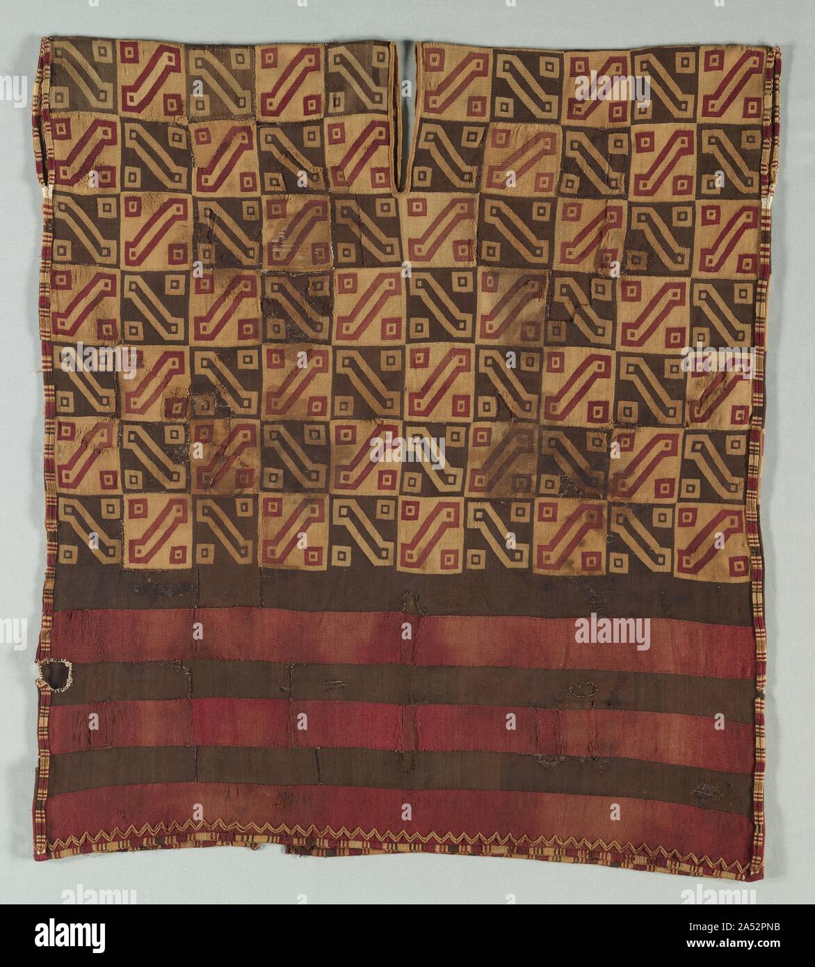 Tunic, c. 1400-1540. Finely woven interlocked tapestry garments were a privilege of the nobility within the Inca Empire. Such garments were made throughout the vast Inca territory by women of noble families, by professional weavers, and by the Aclla (Chosen Women). These specialists lived in cloistered communities and served the state by brewing beer and weaving fine cloth. The products of their labor were redistributed by the Inca state as prized gifts to loyal vassals and allies. The standardized decorative scheme of this tunic, known as the Inca Key, is one of the most common Inca tunic pat Stock Photo